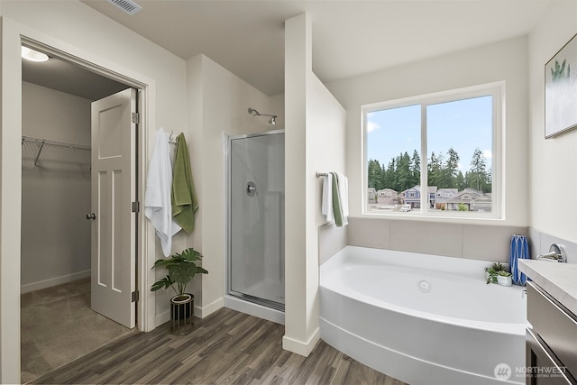 9018 Viola St SE, Tumwater, WA 98501 - full bathroom with a shower stall, a garden tub, a walk in closet, wood finished floors, and vanity