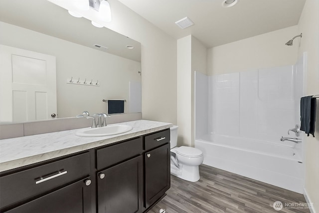 9018 Viola St SE, Tumwater, WA 98501 - full bathroom with vanity, wood finished floors, and bathing tub / shower combination