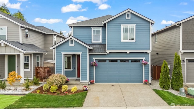 9018 Viola St SE, Tumwater, WA 98501 - traditional-style house with concrete driveway, an attached garage, and roof with shingles