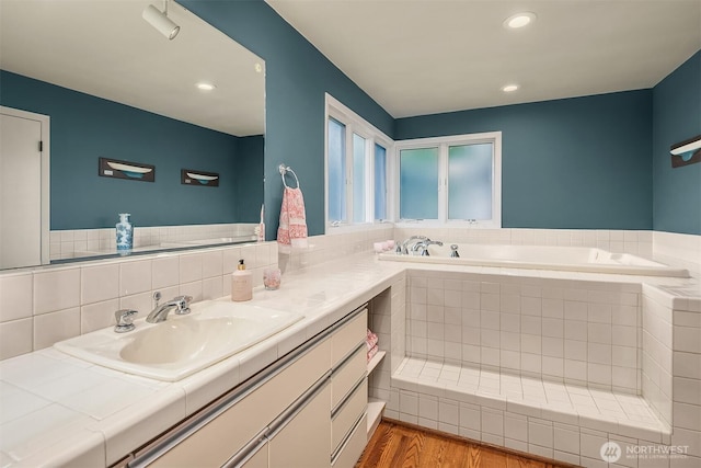 7761 Lakemont Dr NE, Seattle, WA 98115 - full bathroom with a bath, vanity, wood finished floors, and recessed lighting