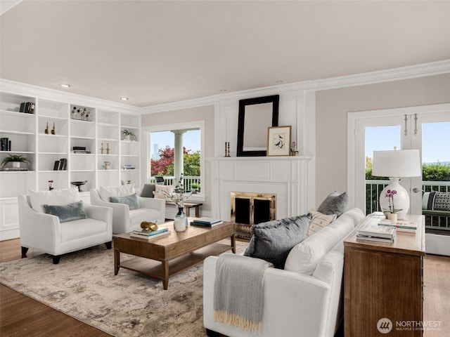 526 W Kinnear Pl, Seattle, WA 98119 - living room featuring ornamental molding, plenty of natural light, wood finished floors, a fireplace, and ornate columns