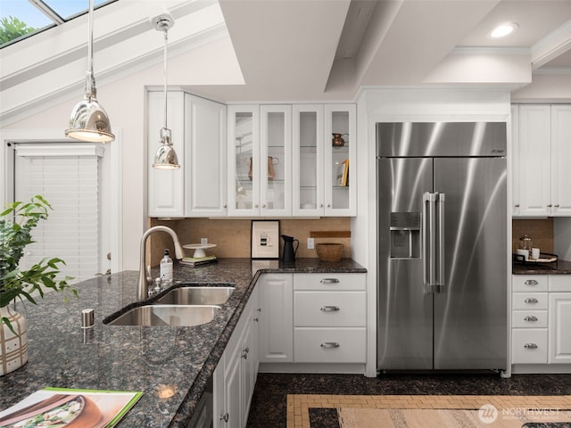 526 W Kinnear Pl, Seattle, WA 98119 - kitchen featuring stainless steel built in refrigerator, white cabinetry, glass insert cabinets, backsplash, and decorative light fixtures