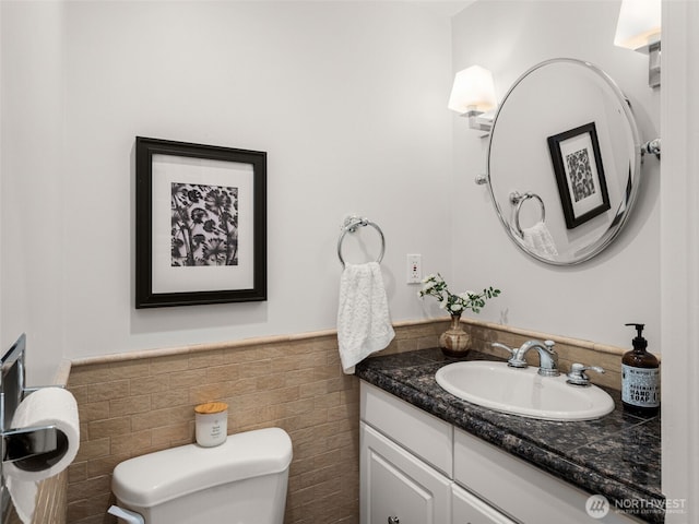 526 W Kinnear Pl, Seattle, WA 98119 - bathroom featuring tile walls, vanity, and a wainscoted wall