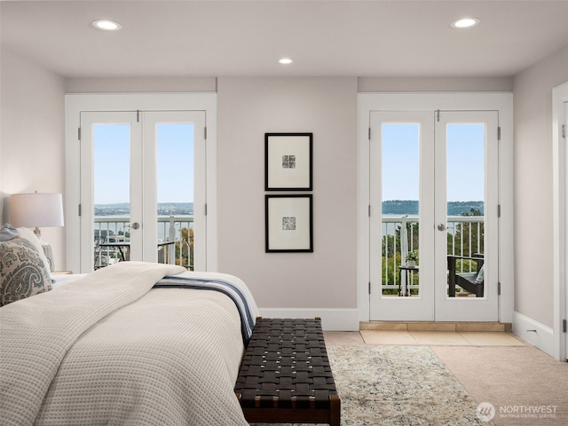 526 W Kinnear Pl, Seattle, WA 98119 - bedroom with french doors, access to exterior, recessed lighting, a water view, and tile patterned flooring