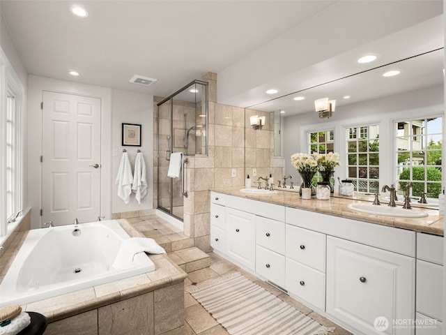 526 W Kinnear Pl, Seattle, WA 98119 - full bath featuring double vanity, a bath, recessed lighting, and a stall shower