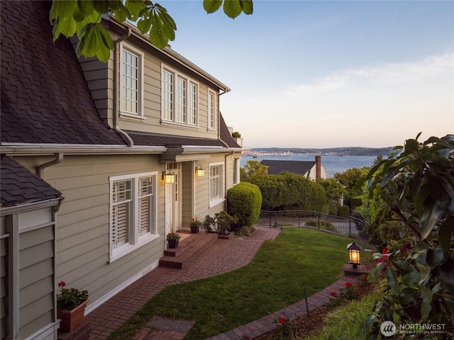526 W Kinnear Pl, Seattle, WA 98119 - yard at dusk with a water view and a patio area