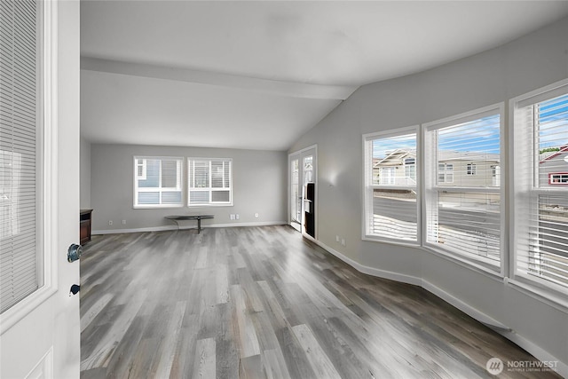 1000 State Route 150 Unit 18, Manson, WA 98831 - unfurnished living room with wood finished floors, vaulted ceiling, and healthy amount of natural light