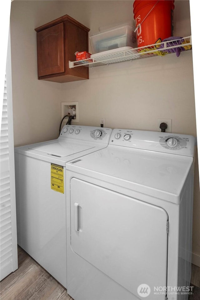 1000 State Route 150 Unit 18, Manson, WA 98831 - laundry area featuring cabinet space, washing machine and dryer, and light wood-style floors