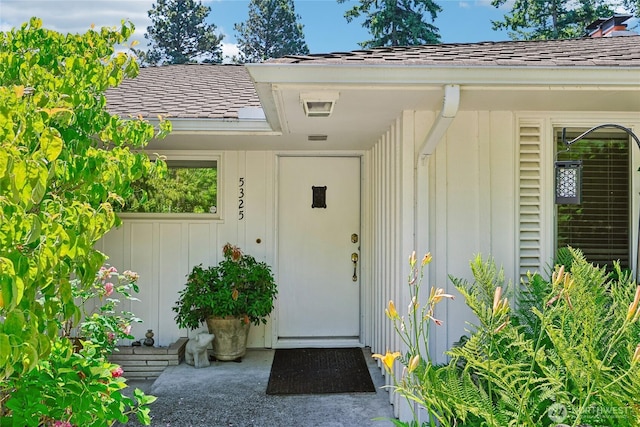 5325 Monta Vista Dr E, Edgewood, WA 98372 - property entrance featuring a shingled roof and board and batten siding
