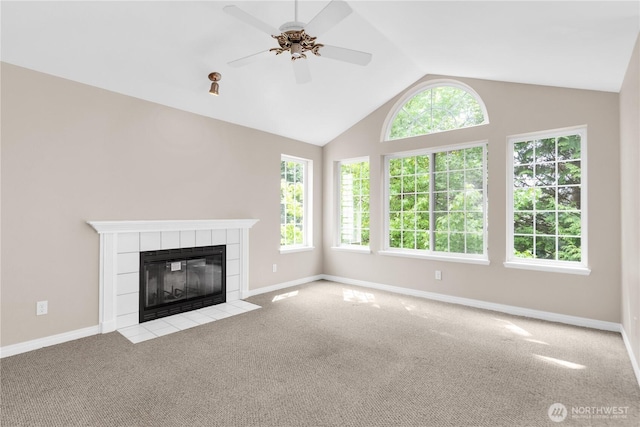 1628 118th Ave SE Unit F316, Bellevue, WA 98005 - unfurnished living room with carpet, a tiled fireplace, ceiling fan, and vaulted ceiling