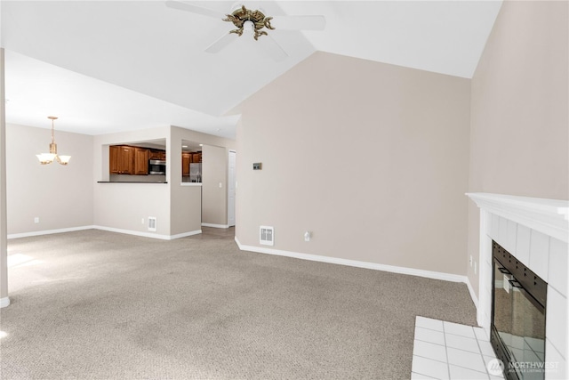 1628 118th Ave SE Unit F316, Bellevue, WA 98005 - unfurnished living room with light colored carpet, a tile fireplace, ceiling fan, vaulted ceiling, and a chandelier