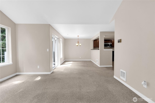 1628 118th Ave SE Unit F316, Bellevue, WA 98005 - spare room with a chandelier and light colored carpet