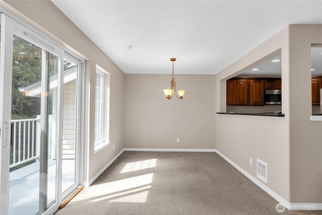 1628 118th Ave SE Unit F316, Bellevue, WA 98005 - unfurnished dining area with a chandelier, carpet flooring, and recessed lighting