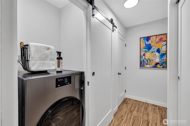 11701 100th Ave NE Unit 2, Kirkland, WA 98034 - laundry area with washer / clothes dryer, a barn door, and light wood-style floors