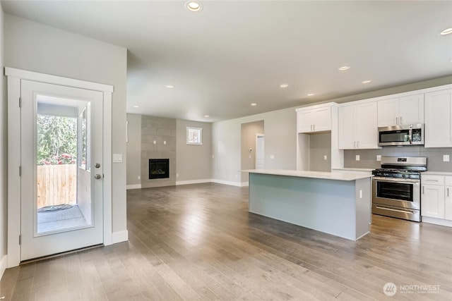 411 205th St SW Unit A, Lynnwood, WA 98036 - kitchen with appliances with stainless steel finishes, plenty of natural light, white cabinets, and recessed lighting