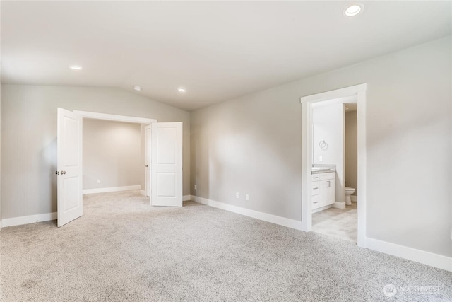 411 205th St SW Unit A, Lynnwood, WA 98036 - unfurnished bedroom featuring light carpet, lofted ceiling, recessed lighting, and connected bathroom