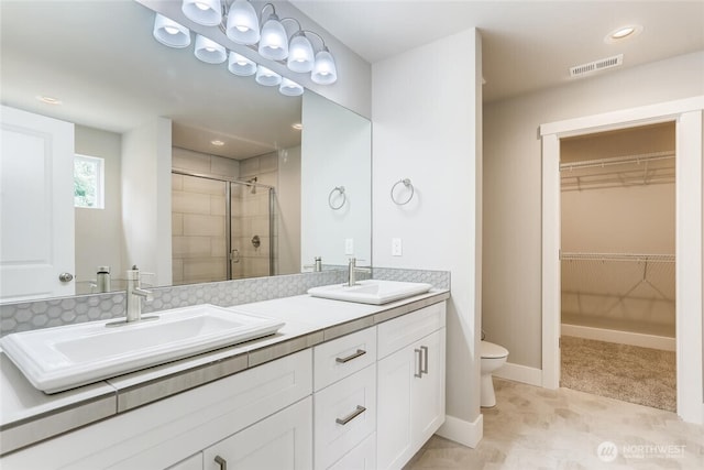 411 205th St SW Unit A, Lynnwood, WA 98036 - full bathroom with double vanity, a stall shower, a walk in closet, and recessed lighting
