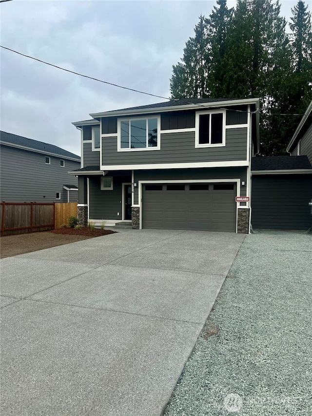 411 205th St SW Unit A, Lynnwood, WA 98036 - view of front of home featuring stone siding, a garage, and driveway
