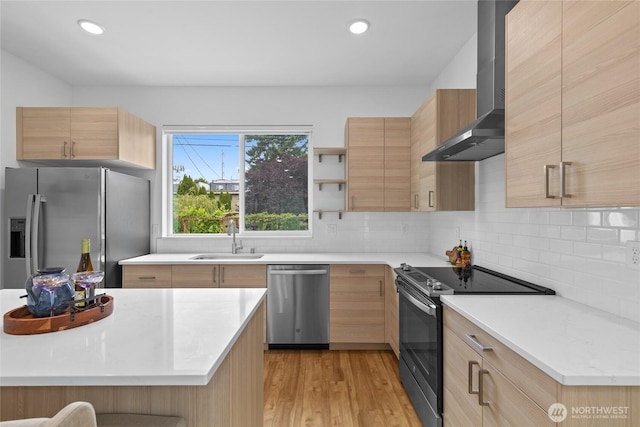 9228 21st Ave SW, Seattle, WA 98106 - kitchen with appliances with stainless steel finishes, wall chimney exhaust hood, light brown cabinetry, light countertops, and recessed lighting