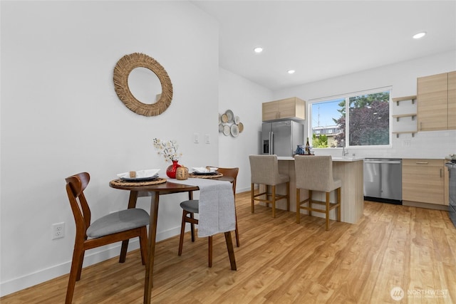 9228 21st Ave SW, Seattle, WA 98106 - dining area featuring light wood finished floors and recessed lighting