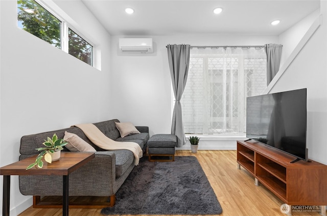 9228 21st Ave SW, Seattle, WA 98106 - living area featuring an AC wall unit, wood finished floors, and recessed lighting