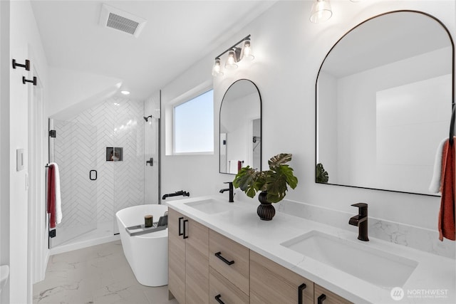 9228 21st Ave SW, Seattle, WA 98106 - full bath with marble look tile flooring, double vanity, a freestanding tub, and a stall shower