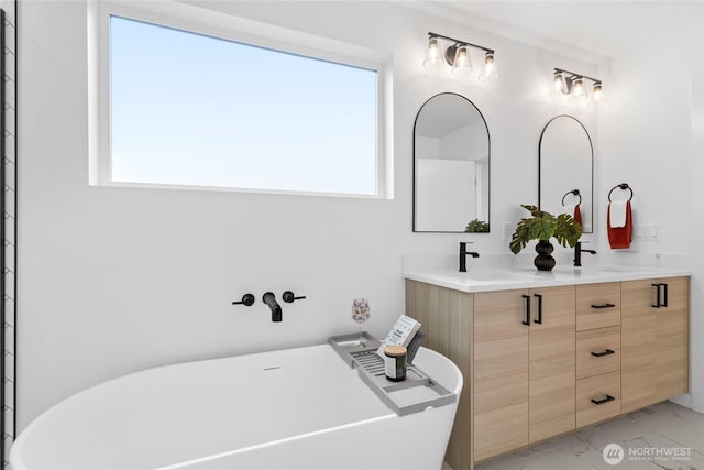 9228 21st Ave SW, Seattle, WA 98106 - full bathroom featuring marble look tiles, a soaking tub, plenty of natural light, and double vanity