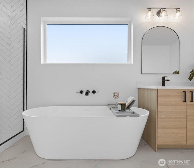 9228 21st Ave SW, Seattle, WA 98106 - full bathroom featuring marble look tile flooring, vanity, plenty of natural light, and a freestanding bath