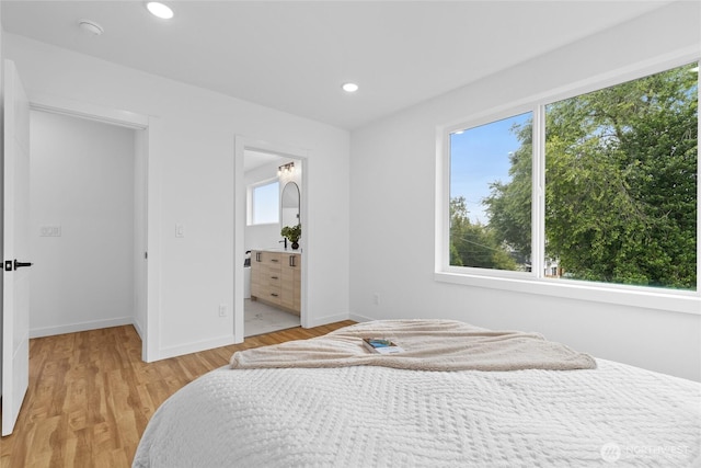 9228 21st Ave SW, Seattle, WA 98106 - bedroom featuring light wood-type flooring, recessed lighting, and ensuite bath