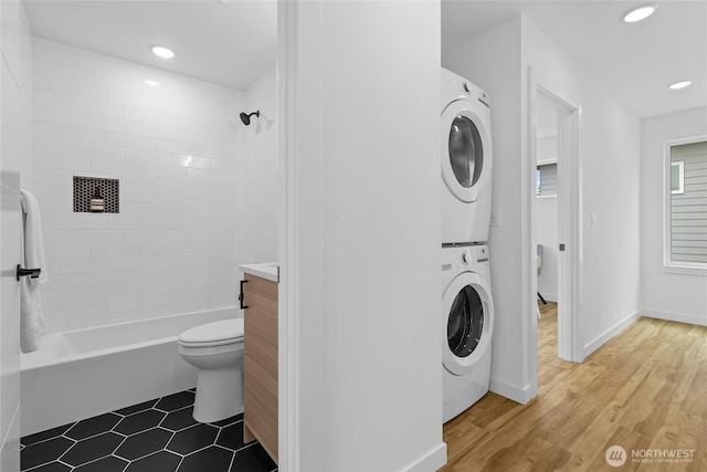 9228 21st Ave SW, Seattle, WA 98106 - laundry area with estacked washer and dryer, recessed lighting, and wood finished floors