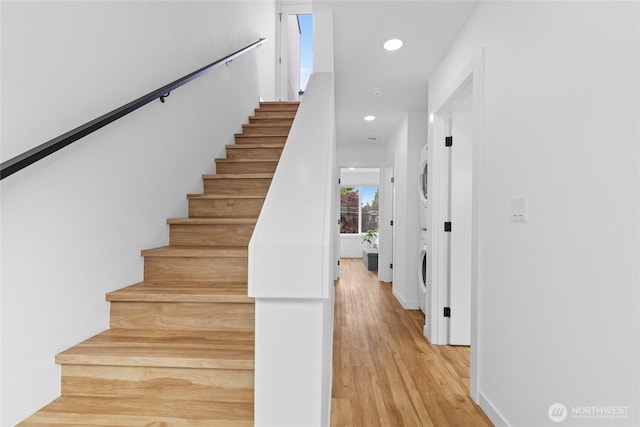 9228 21st Ave SW, Seattle, WA 98106 - stairs with stacked washer / dryer, wood finished floors, and recessed lighting