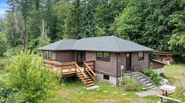 13402 Spring Site Rd E, Orting, WA 98360 - view of front facade featuring stairs, a shingled roof, and a deck