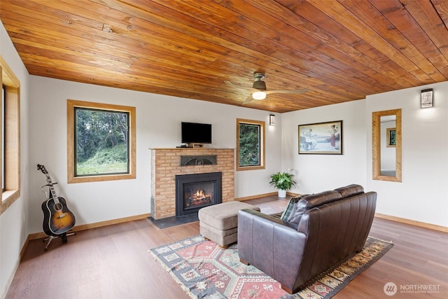 13402 Spring Site Rd E, Orting, WA 98360 - living room featuring a brick fireplace, wood finished floors, wooden ceiling, and a ceiling fan