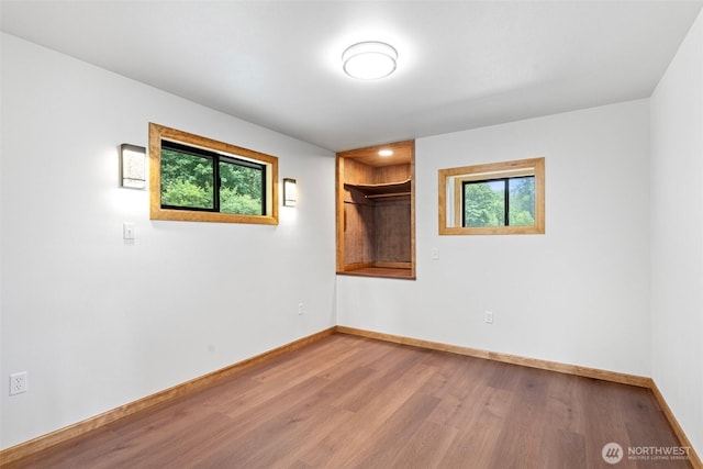 13402 Spring Site Rd E, Orting, WA 98360 - spare room with wood finished floors and plenty of natural light