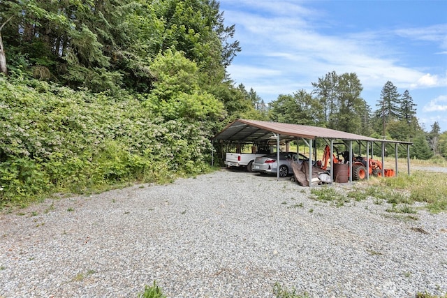 13402 Spring Site Rd E, Orting, WA 98360 - view of parking / parking lot featuring a carport and gravel driveway