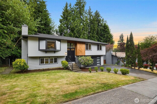 11335 NE 149th St, Kirkland, WA 98034 - bi-level home featuring a chimney, driveway, and an attached garage
