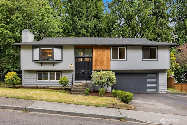 11335 NE 149th St, Kirkland, WA 98034 - view of front facade with a garage, asphalt driveway, a chimney, and roof with shingles