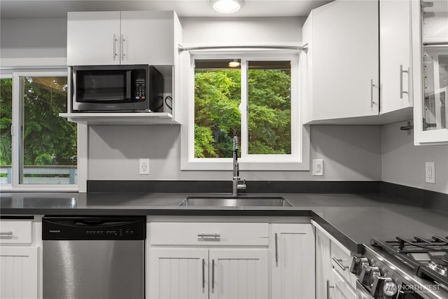 11335 NE 149th St, Kirkland, WA 98034 - kitchen featuring dishwasher, dark countertops, and white cabinetry