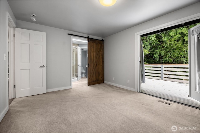 11335 NE 149th St, Kirkland, WA 98034 - unfurnished bedroom with access to exterior, carpet, ensuite bathroom, and a barn door