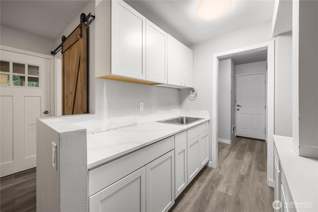 11335 NE 149th St, Kirkland, WA 98034 - kitchen featuring light wood-style floors, white cabinetry, a barn door, and light stone countertops