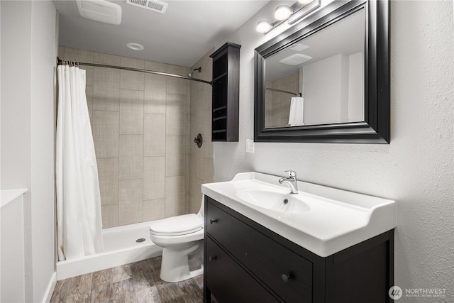 11335 NE 149th St, Kirkland, WA 98034 - bathroom with vanity, wood finished floors, a tile shower, and a textured wall
