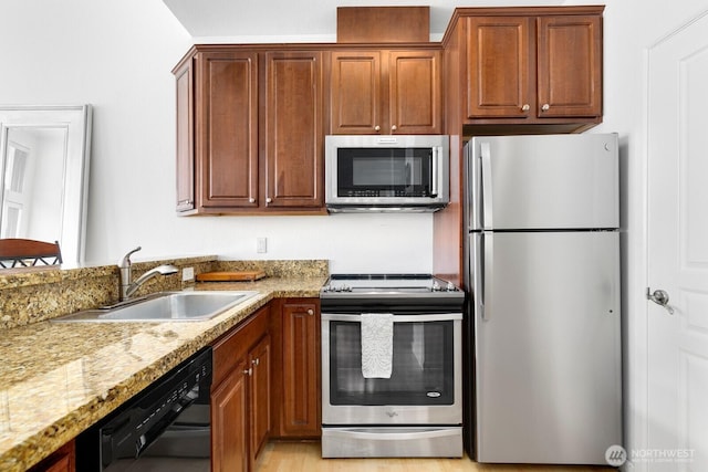 225 Logan Ave S Unit B355, Renton, WA 98057 - kitchen featuring stainless steel appliances, light stone countertops, and brown cabinets