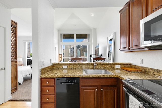 225 Logan Ave S Unit B355, Renton, WA 98057 - kitchen featuring stainless steel appliances, light stone countertops, a peninsula, and light wood-style floors