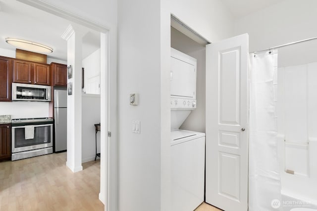 225 Logan Ave S Unit B355, Renton, WA 98057 - laundry room with stacked washer / dryer and light wood-style flooring