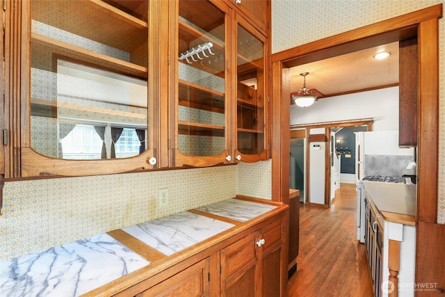 3402 N 28th St, Tacoma, WA 98407 - kitchen featuring white appliances, dark wood-type flooring, and brown cabinetry