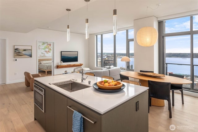 2510 6th Ave Unit 3605, Seattle, WA 98121 - kitchen featuring light wood finished floors, plenty of natural light, floor to ceiling windows, and a center island with sink