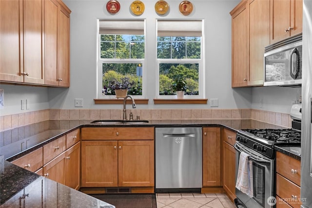 17356 Red Hawk Ct, Mount Vernon, WA 98274 - kitchen featuring appliances with stainless steel finishes, dark stone countertops, and light tile patterned floors