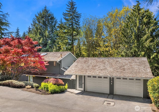 6160 W Mercer Way, Mercer Island, WA 98040 - view of front of house featuring stucco siding, a garage, and driveway
