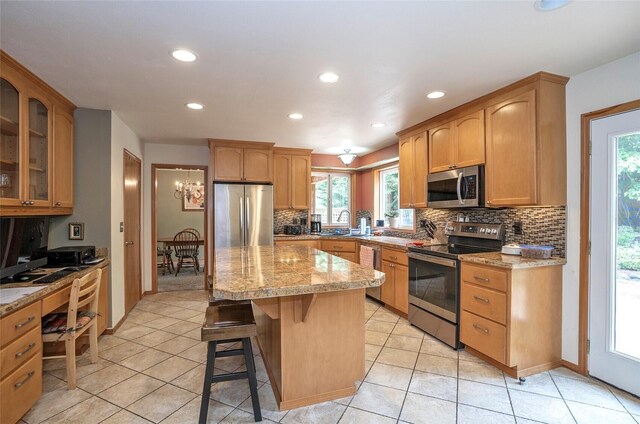 2003 88th Ave W, University Place, WA 98466 - kitchen with appliances with stainless steel finishes, tasteful backsplash, plenty of natural light, a kitchen breakfast bar, and recessed lighting
