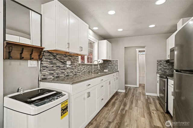 2440 Rock Island Rd, East Wenatchee, WA 98802 - kitchen featuring appliances with stainless steel finishes, wood finished floors, white cabinets, recessed lighting, and tasteful backsplash